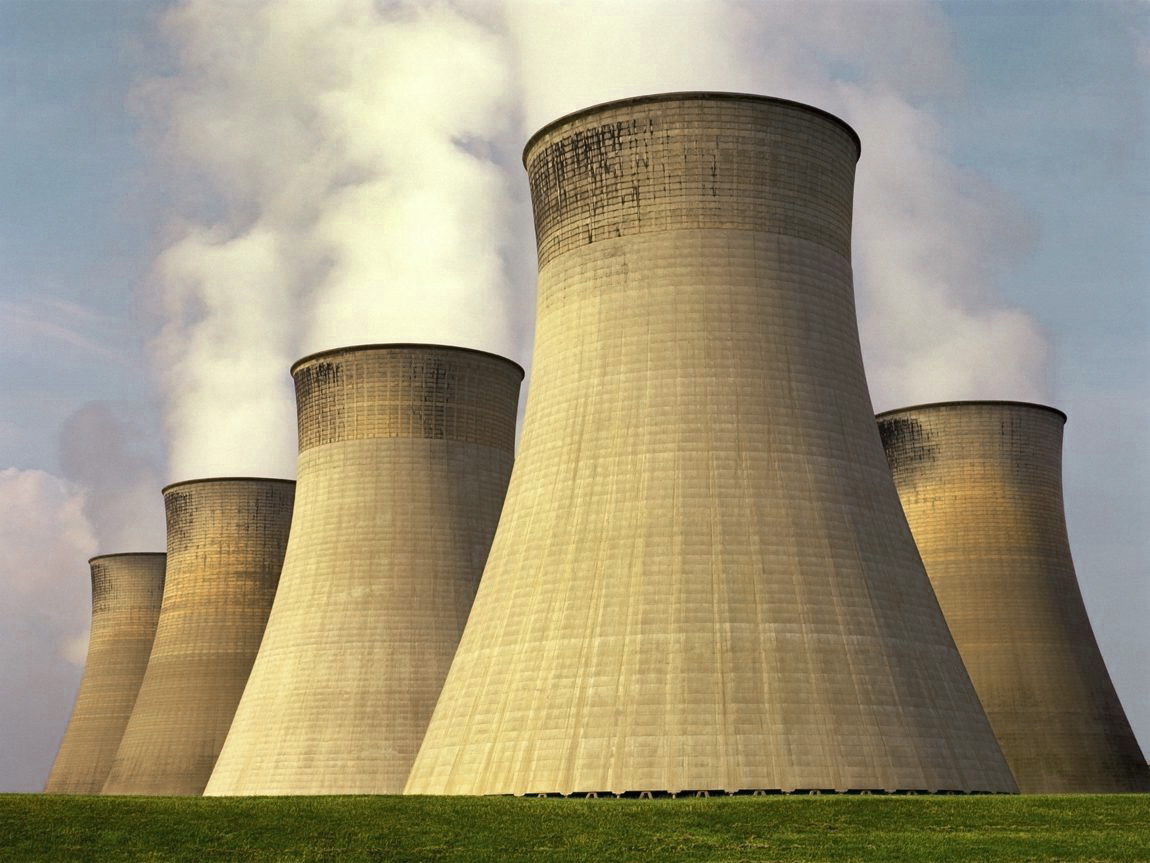 Cooling towers of a nuclear fission power plant releasing water vapour