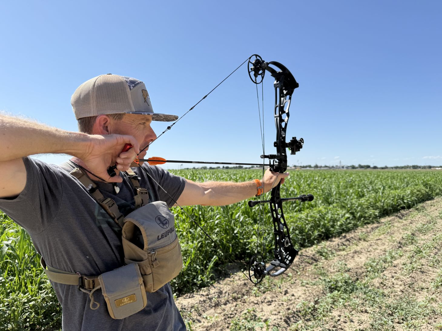 Archer at full draw storing elastic potential energy in a bent bow