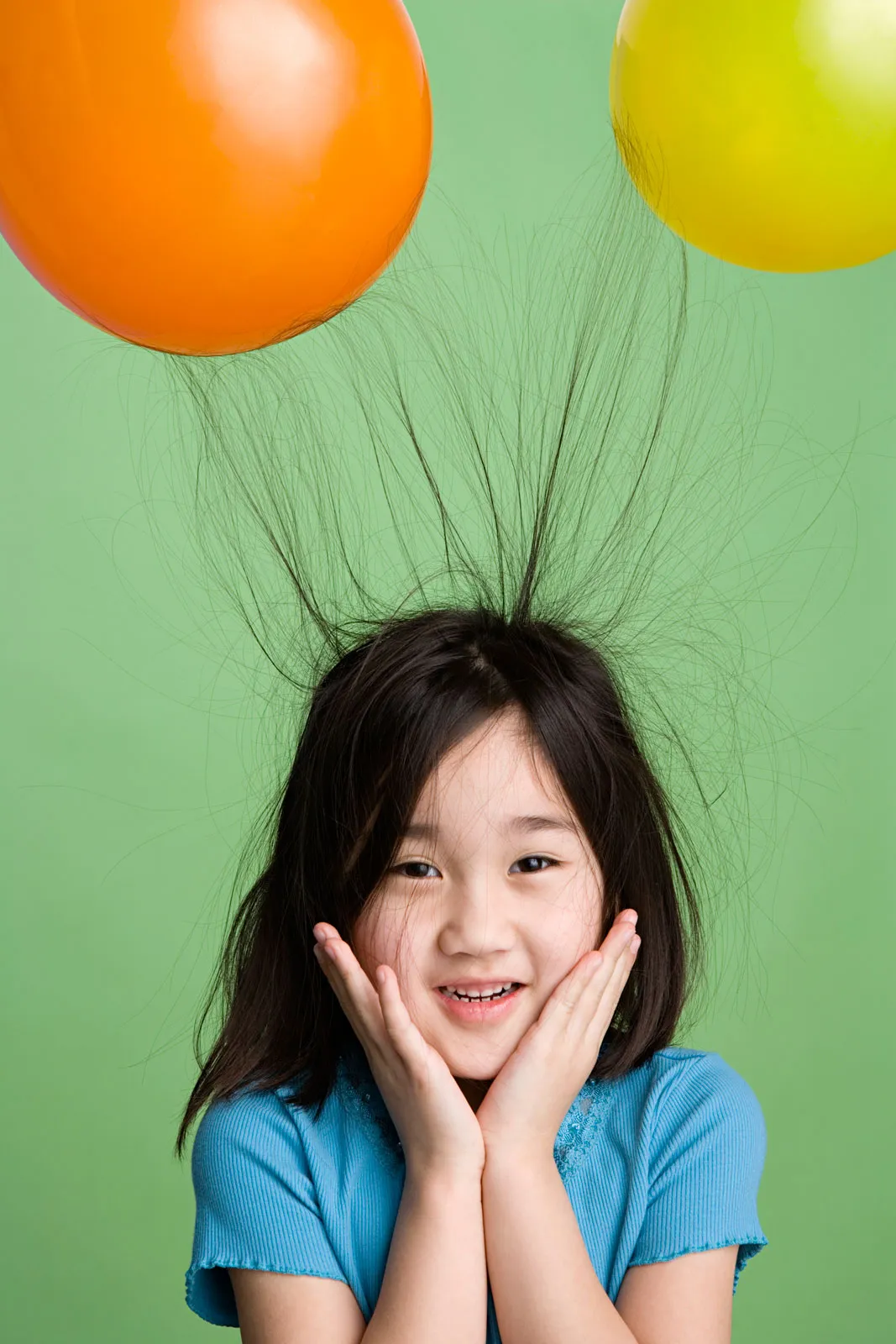 Child's hair standing on end from static electricity, strands repelling each other