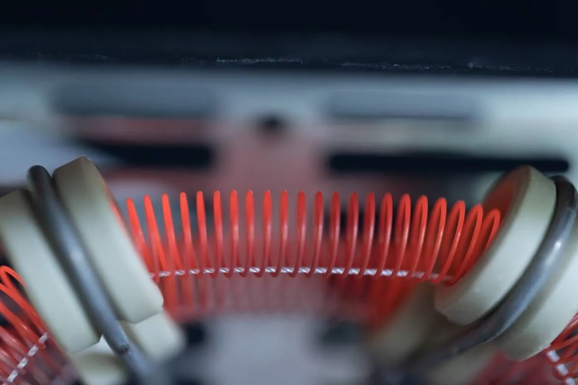 Glowing nichrome heating element demonstrating high electrical resistance converting current into heat