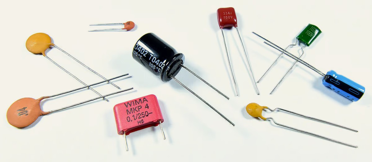 Assorted capacitors showing ceramic disc, film and electrolytic types with different capacitance values