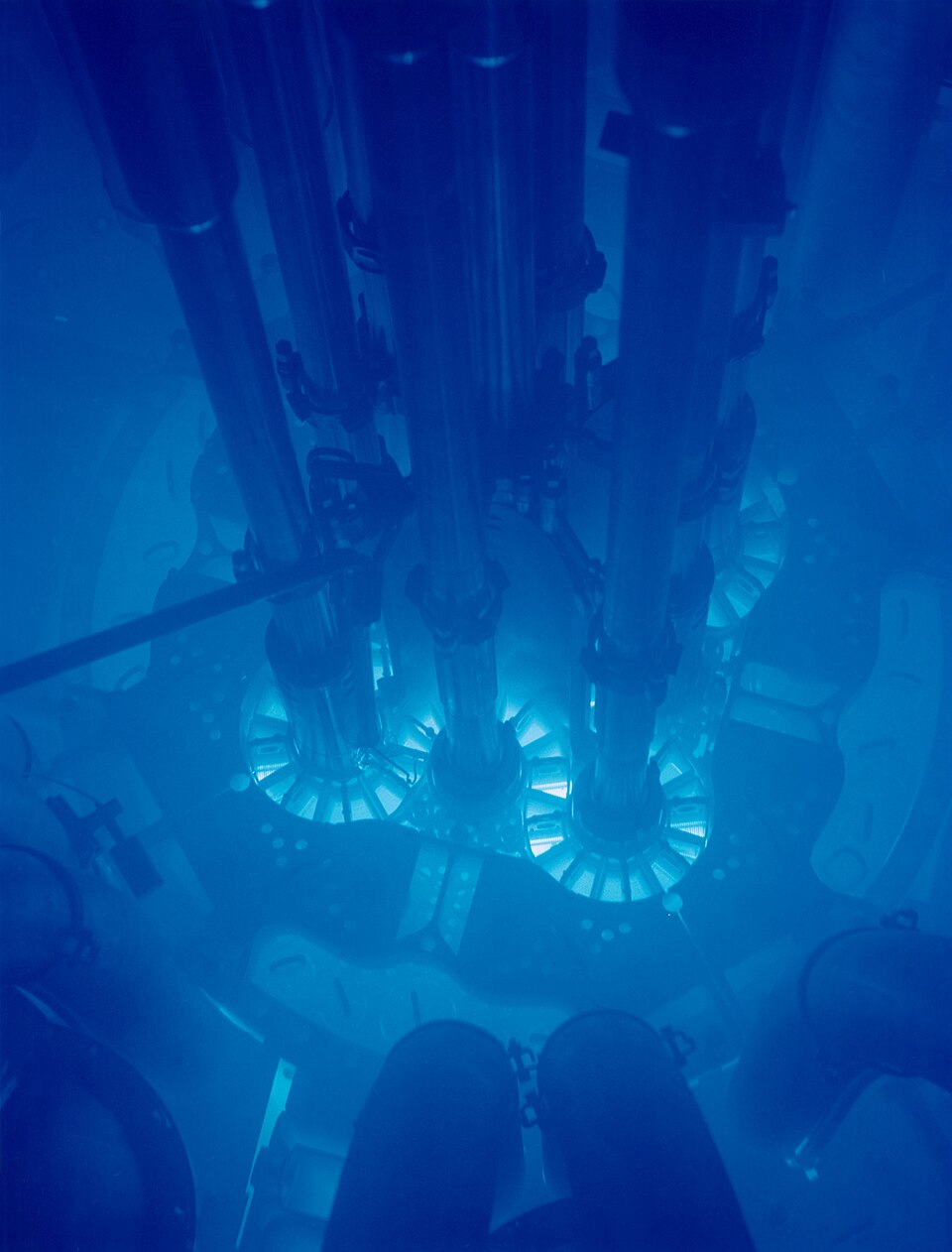 Blue Cherenkov glow around a nuclear reactor core submerged in a cooling pool
