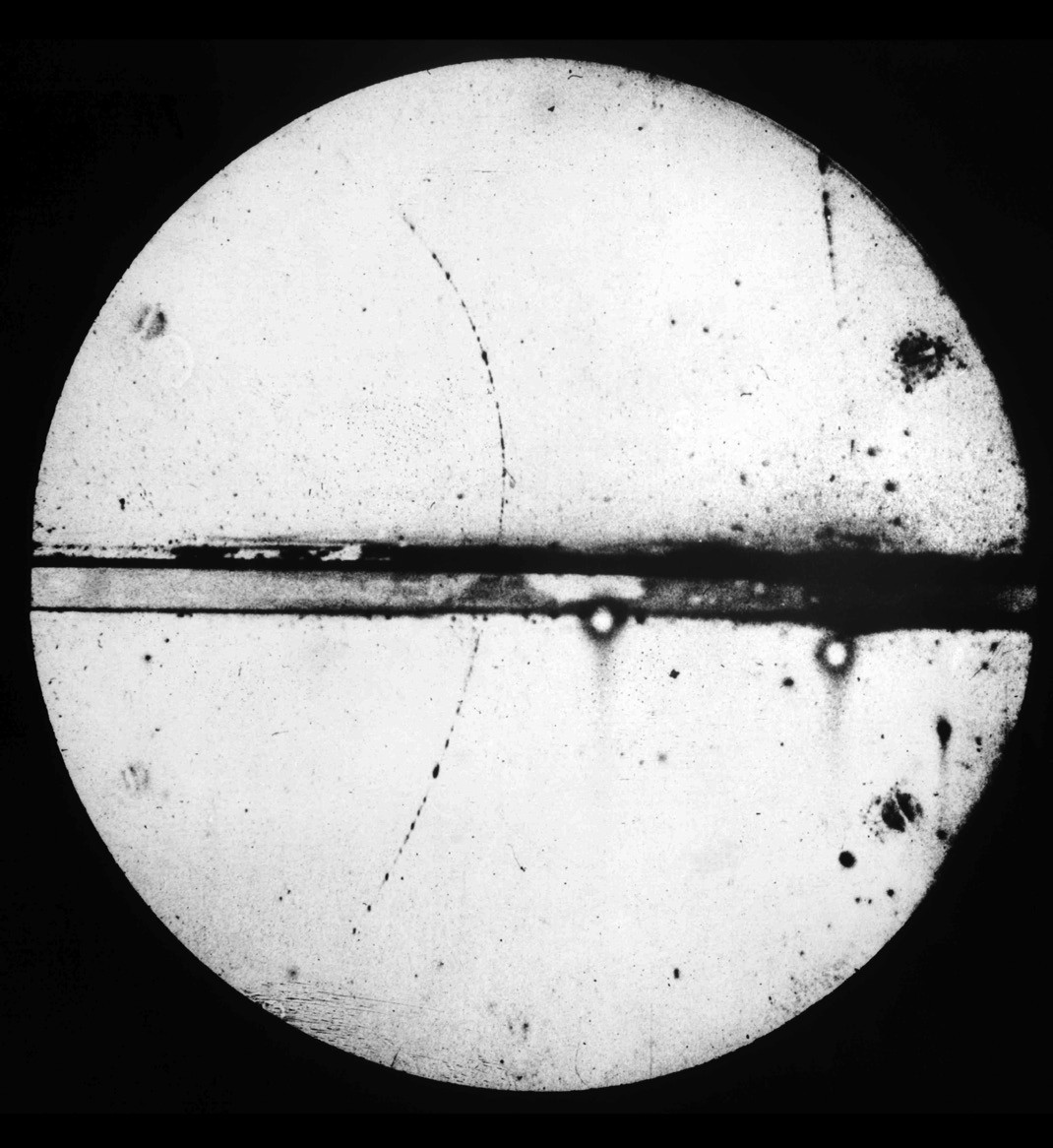 Cloud chamber photograph showing the curved track of a positron, the first antimatter particle discovered