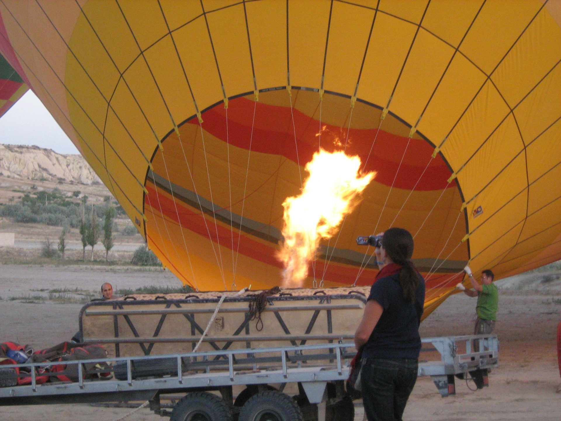Hot-air balloon being inflated with the burner firing, one of the gas laws at work as the heated air expands at constant pressure