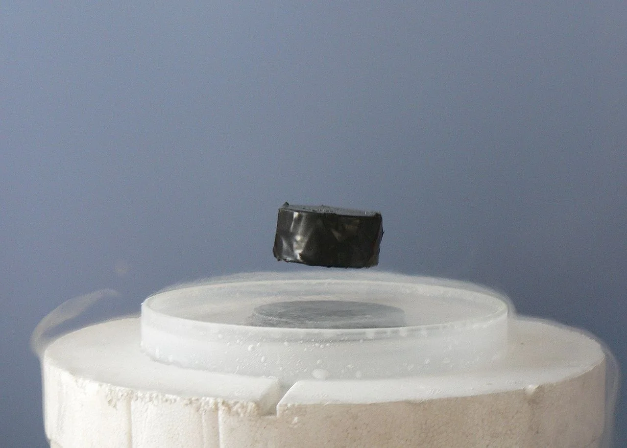 A magnet hovering above a chilled superconductor, the demonstration most people have seen of the effect