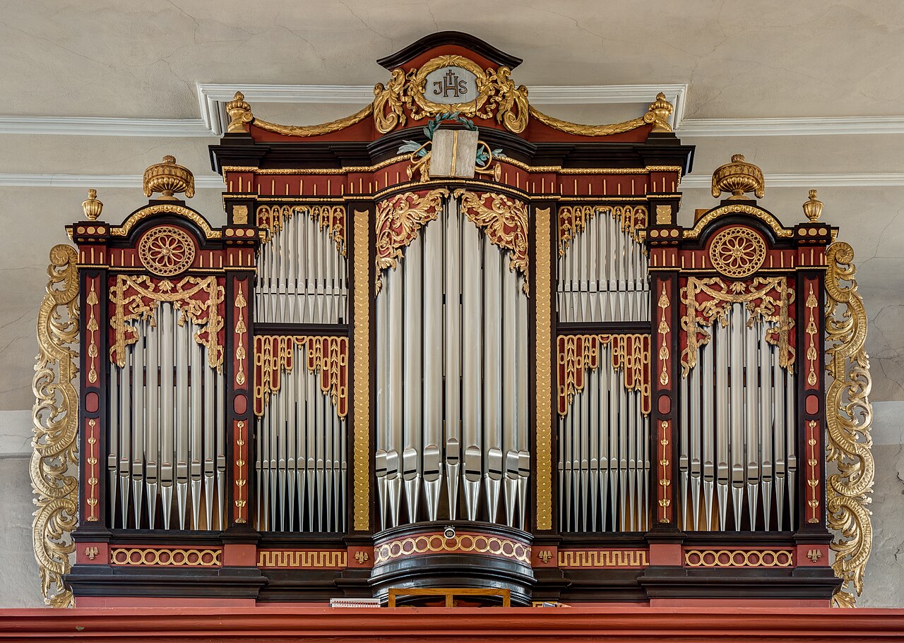 A rank of organ pipes of different lengths, the standing waves inside each one setting its pitch